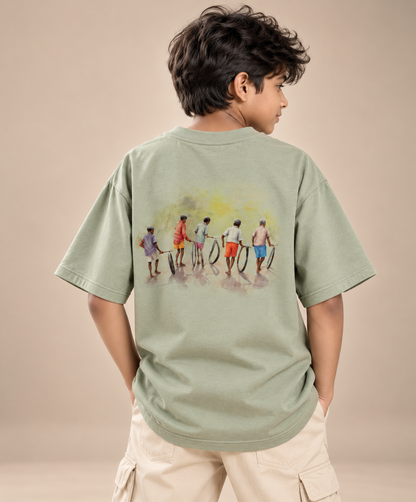 Boy wearing Chase the Sun kids & teens oversized cotton t-shirt in sage green